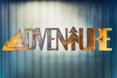 Adventure Metal Wall Art is the word adventure cut out of metal with a mountain for the letter A and a tree for the letter T