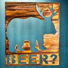Beer Bear Deer Metal Art is a square piece of metal with a bear with deer antlers and the phrase Beer? in below the image.