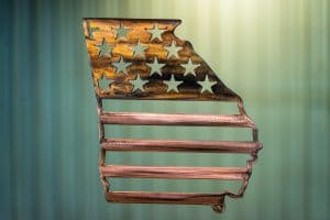 Metal wall art depicting an outline of the state of Georgia with American Flag across the outline of the state.