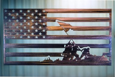 Metal wall art of an American Flag made of metal depicting the image of Raising the Flag at Iwo Jima finished with a Camo Patina