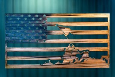 Metal wall art of an American Flag made of metal depicting the image of Raising the Flag at Iwo Jima finished with a Camo Patina
