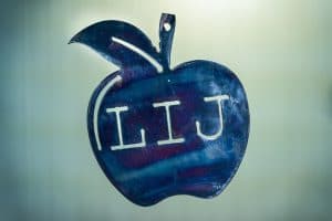 Metal art shaped apple with L-I-J in middle.