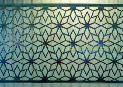 Geometric Metal Art Screen wall decor has flower patterns in a geometric shape.