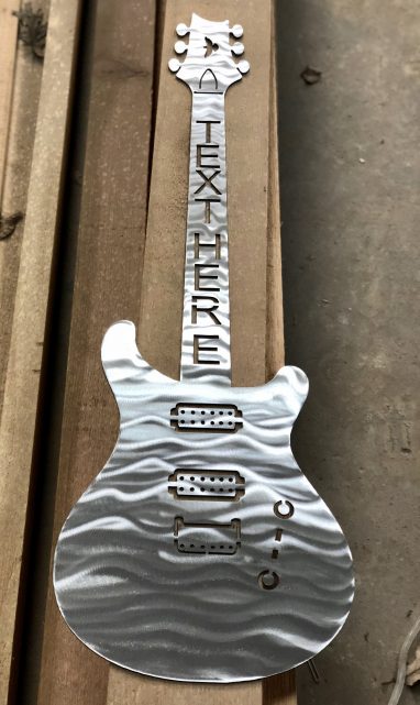 Metal wall art of guitar with ability to add text to neck of guitar.