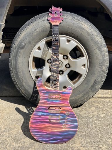 Metal wall art of guitar with ability to add text to neck of guitar.