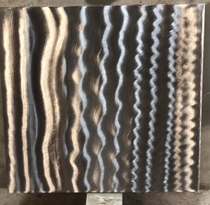 Sample photo of a clear coat finish from Artful MetalWorx metal art. The metal has a bright silver look that accents the polished steel showing the grinder marks where the metal was hand finished.