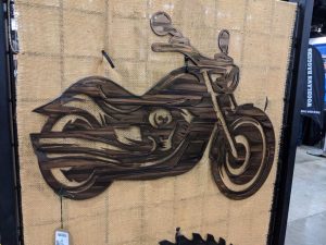 Metal wall art of motorcycle on screen used for festivals
