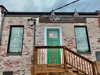Photo shows the back of Artful Ellijay a retail home decor store in Downtown Ellijay. This picture show Artful MetalWorx metal art for the Artful Ellijay Home Provisions letters as well as the custom screens in the windows.
