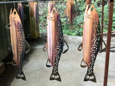 Metal wall art trout hanging at the shop. This has a Wood Grain Copper finish.