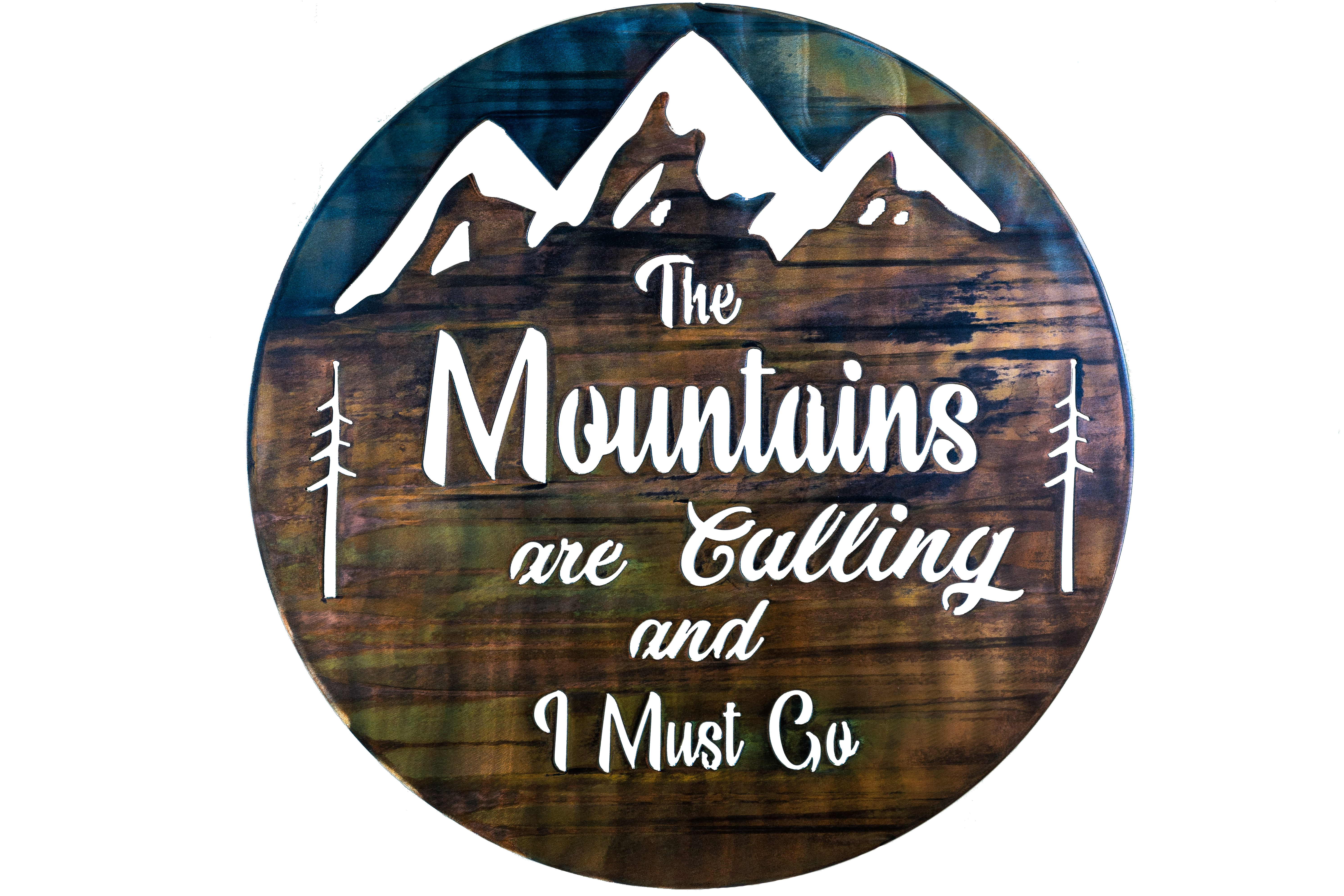 The Mountains are calling and I must go metal wall art is a circular piece of metal with the phrase cut into the metal with mountains in the background.