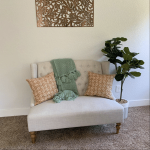 Metal Art Wall Decor rectangular Screen with Floral pattern and a wood grain copper patina. This photo showcases the metal screen indoor as the main statement piece in the living room.
